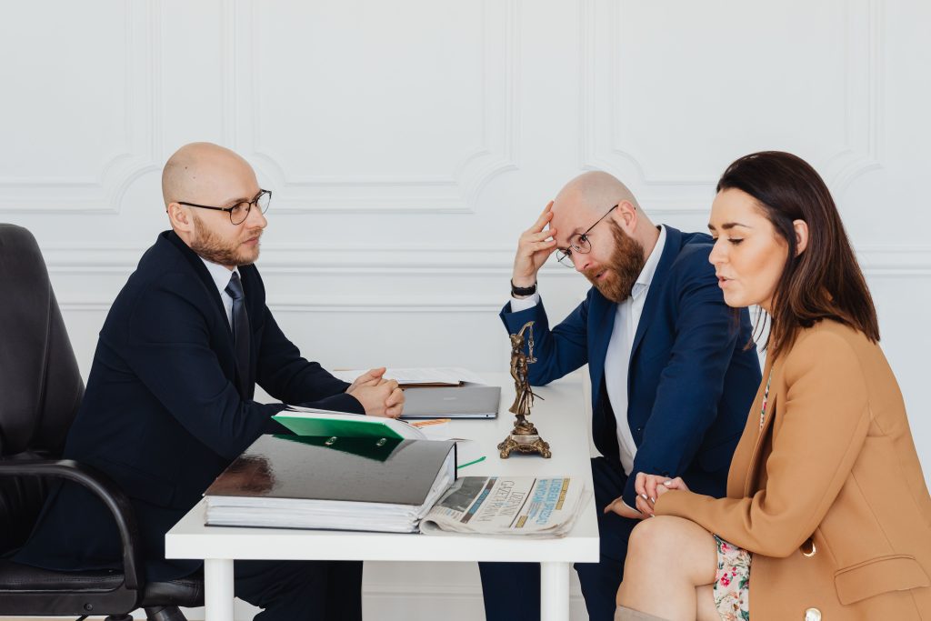 Divorce mediator consulting a couple about their settlement in a calm office setting
