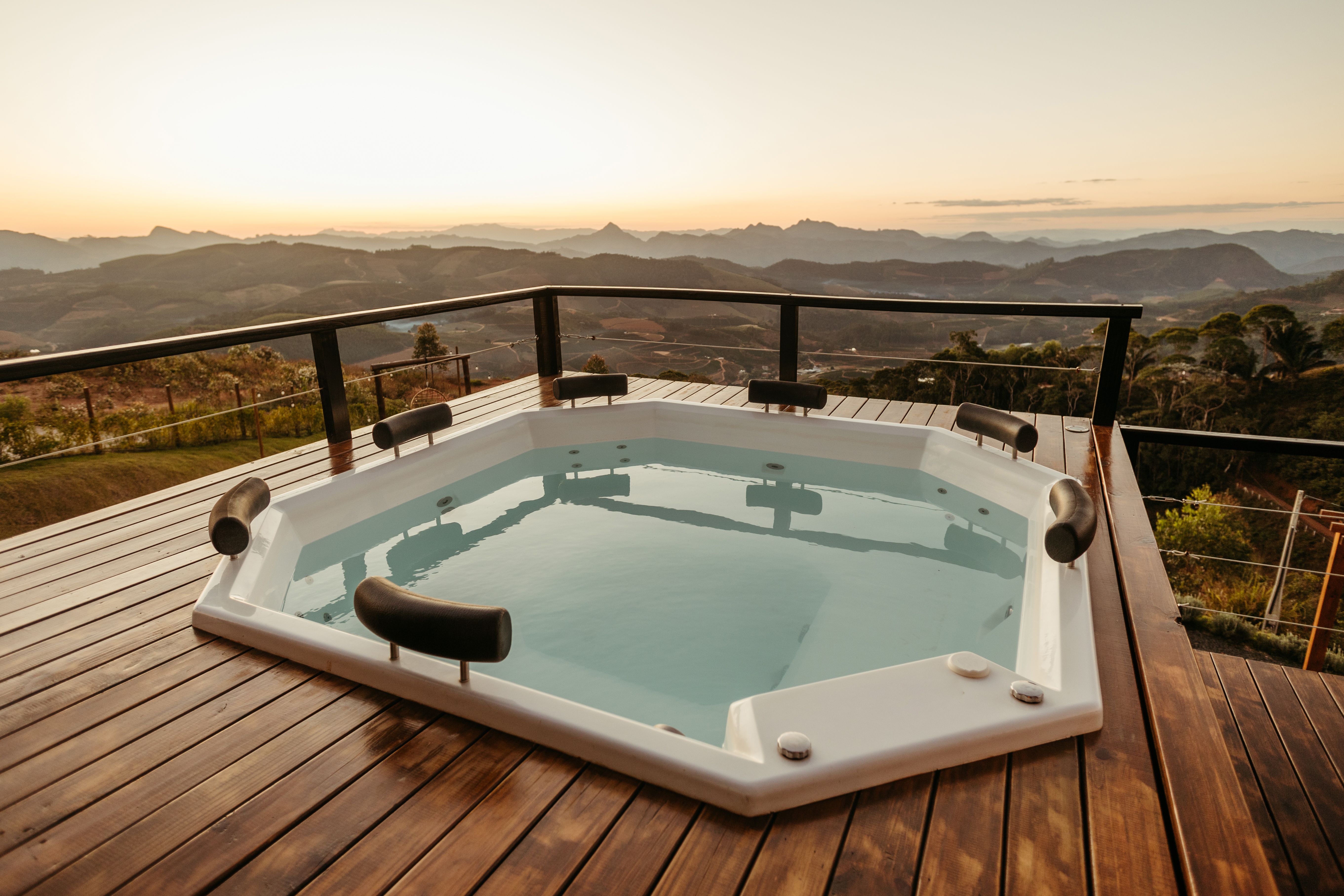 Outdoor hot tub with a stunning mountain view at sunset for a luxury backyard retreat
