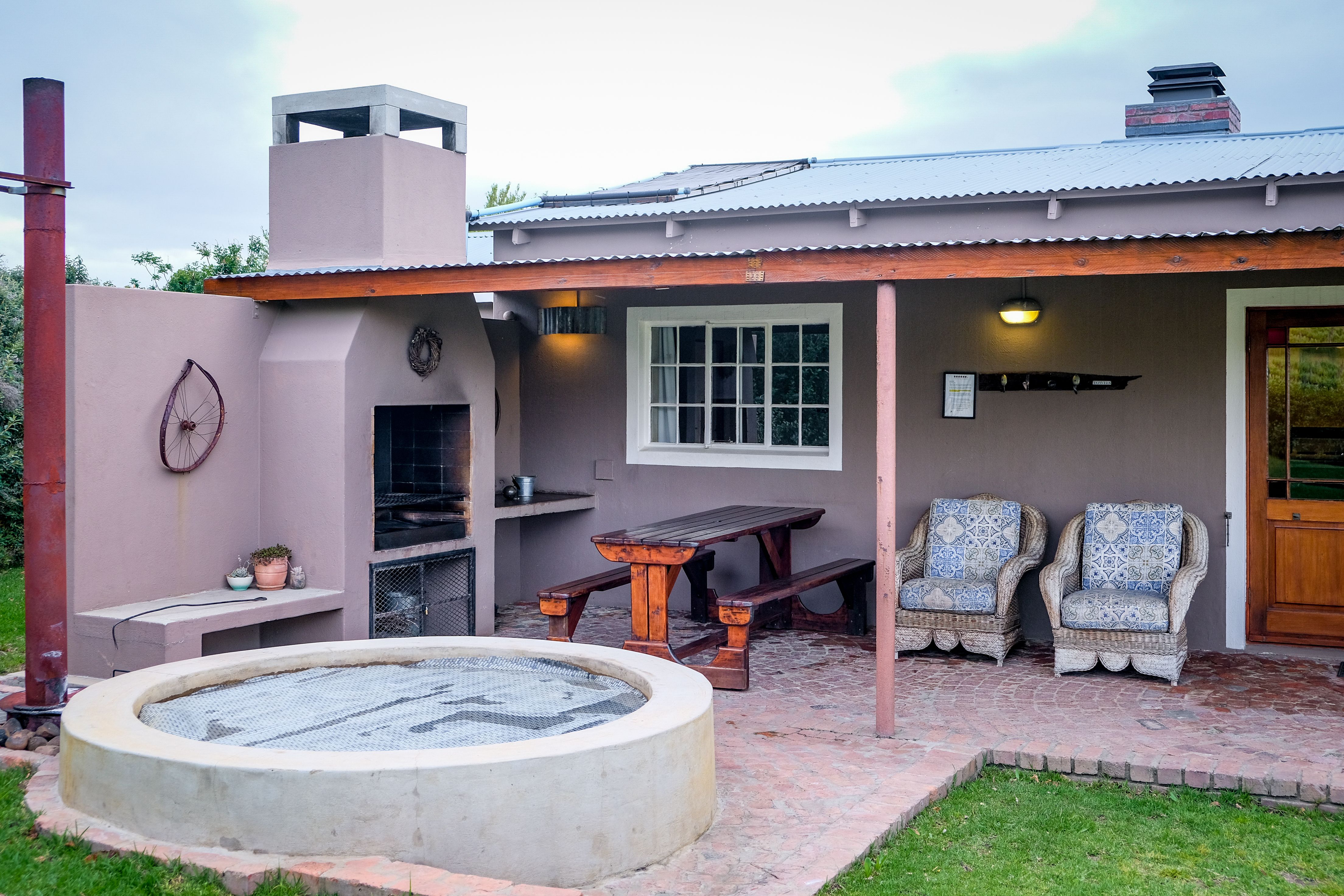 Residential patio with a hot tub and comfortable outdoor seating area ready for use