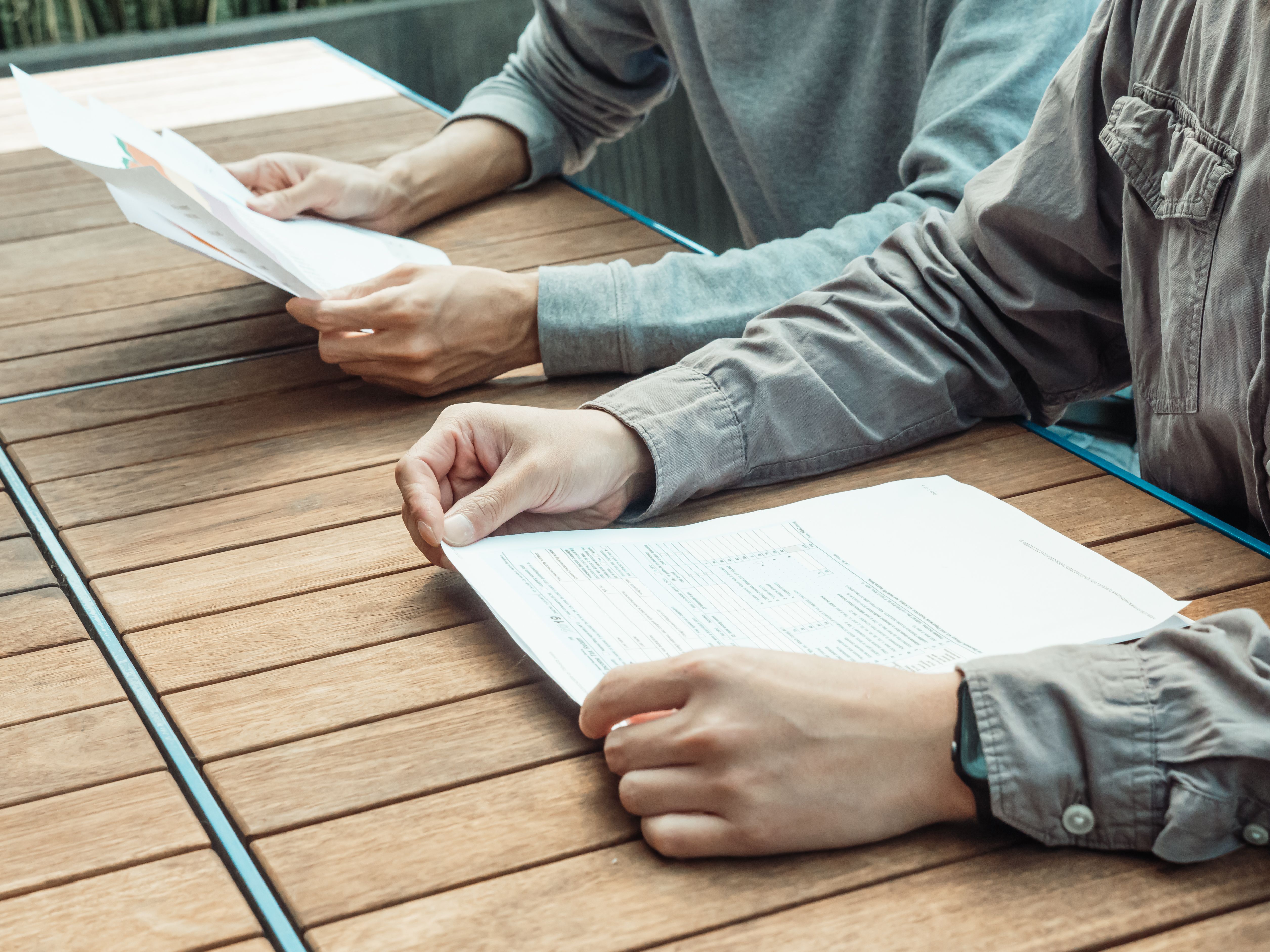 Couple reviewing divorce settlement documents together at a table